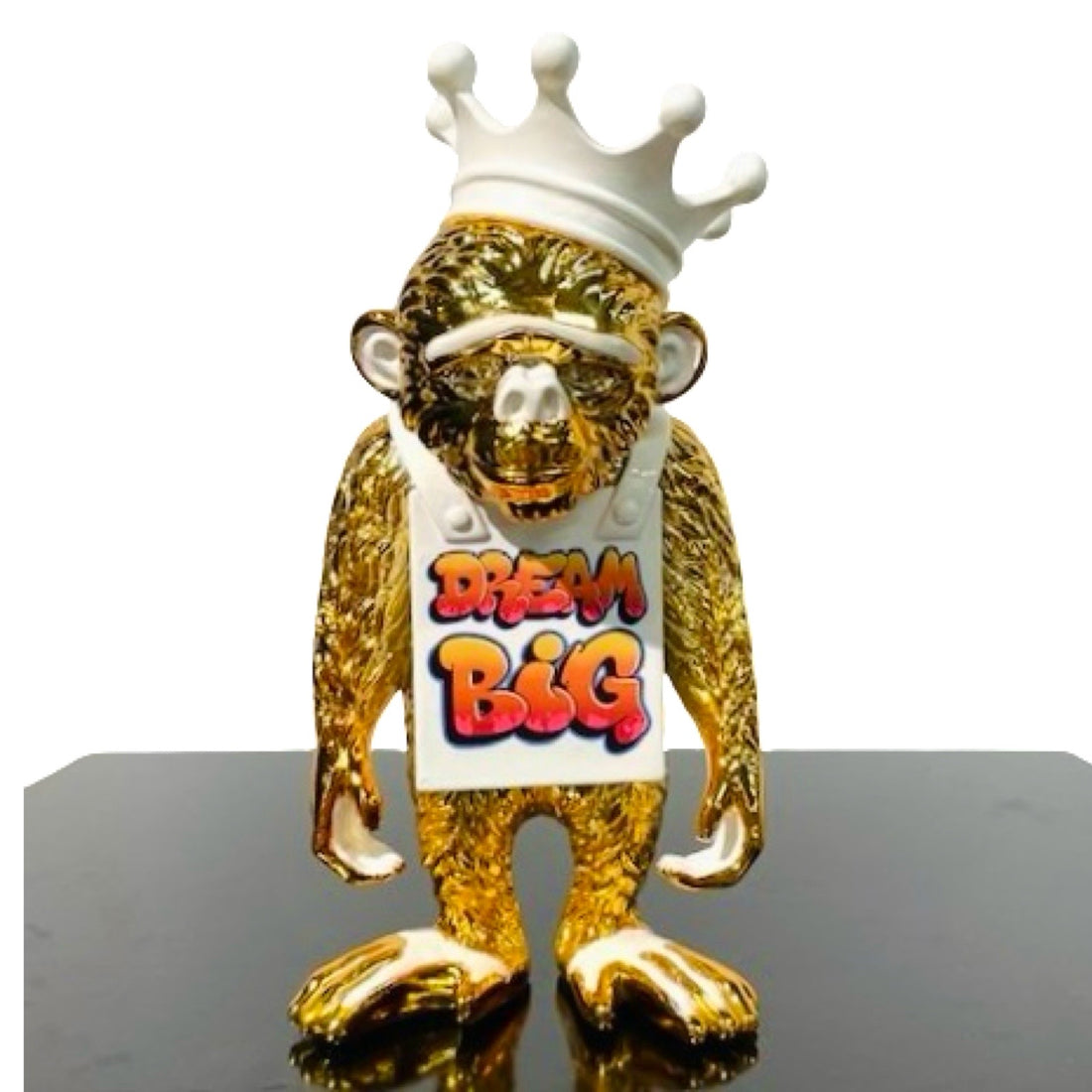 Sculpture of an golden monkey with white Dream Big sign and crown
